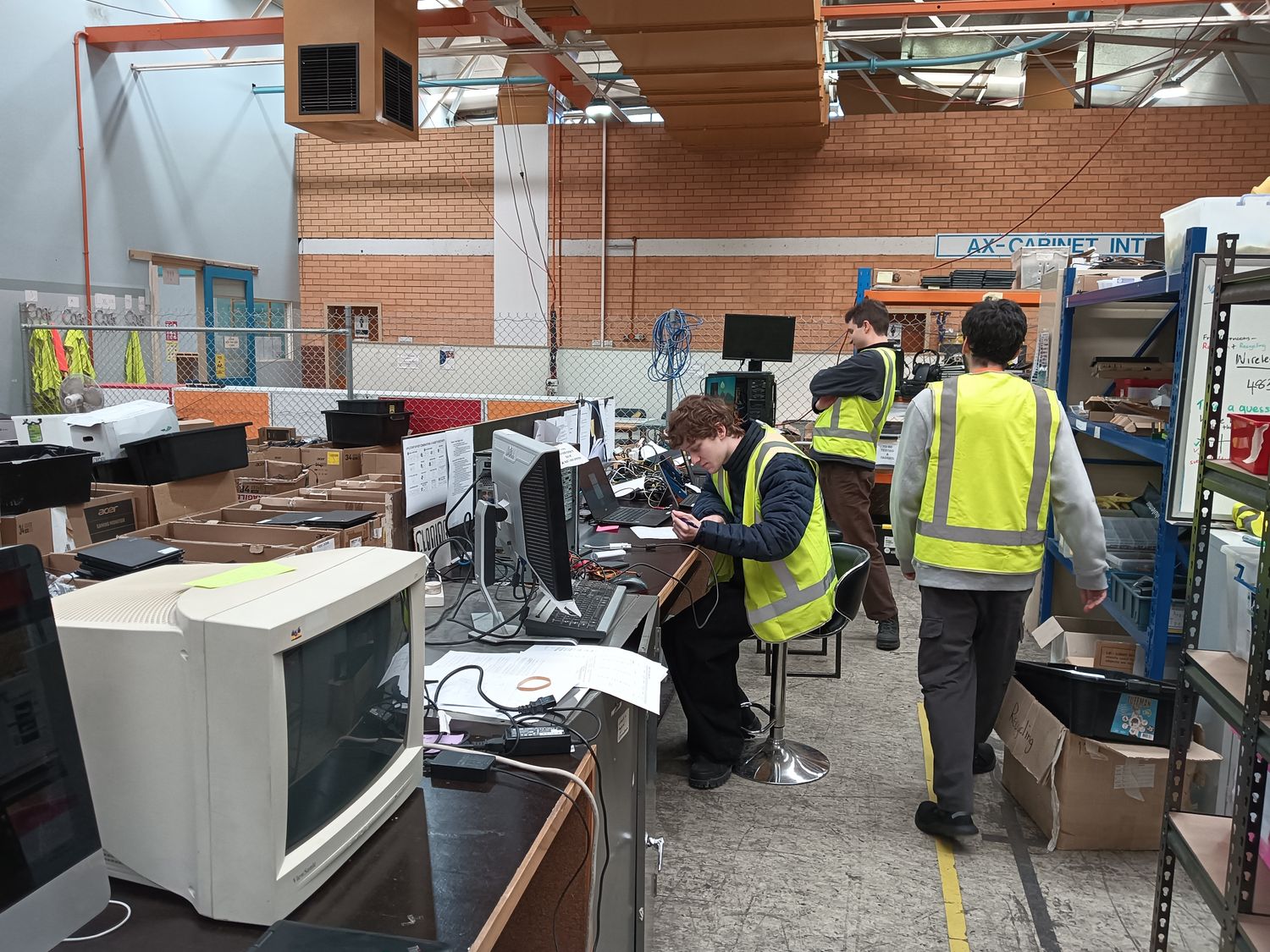 Volunteers at the testing benches in the build room
